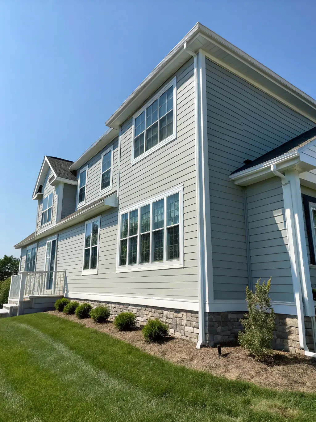A modern house with new vinyl siding in a vibrant color, showcasing the quality of our siding work.
